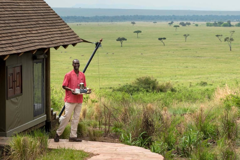 &Beyond Bateleur Camp butler-at-andbeyond-bateleur-camp-overlooking-the-masai-mara