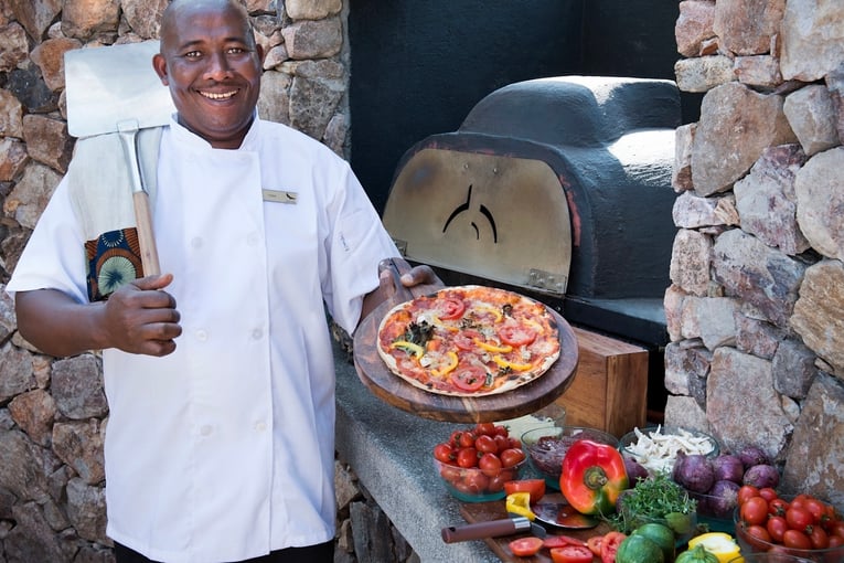 &Beyond Grumeti Serengeti River Lodge Tanzania-Grumeti-Serengeti-River-Lodge-Guest-area-boma-andBeyonder-chef-outdoor-pizza-oven_4