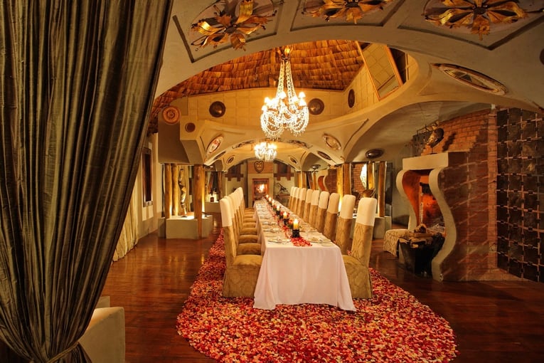 &Beyond Ngorongoro Crater Lodge guest-dining-area-surrounded-by-rose-petals-at-andbeyond-ngorongoro-crater-lodge-on-a-luxury-tanznia-safari