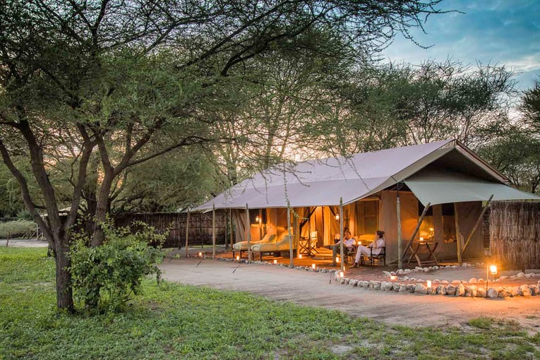 Chem Chem 63495747c486e2dc76edba2a_Little-Chem-Chem-Safari-Tanzania-Accommodation-Luxury-Tented-Camp-Couple-Evening