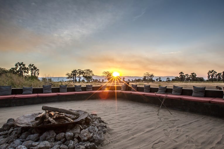 Chem Chem 64008de44ae395a0c4c81dd7_Chem-Chem-Lodge-Safari-Tanzania-East-Africa-Main-Area-Fire-Pit-Sunset