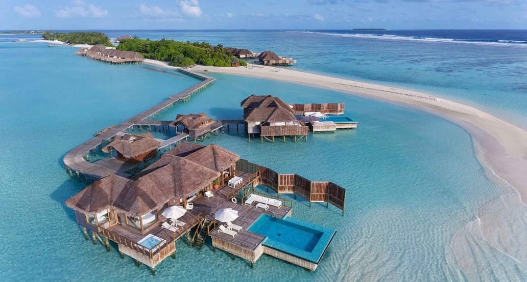 Conrad Maldives Rangali Island Resort_CMRI_Sunset-Water-Villa-Aerial-Angle_HR-1063x614