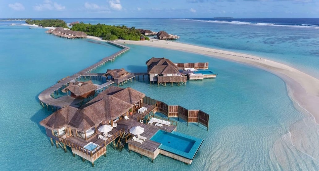 Conrad Maldives Rangali Island Resort_CMRI_Sunset-Water-Villa-Aerial-Angle_HR-1063x614