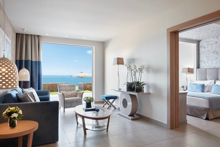 Ikos Olivia Ikos-Olivia-Rooms-Deluxe-Two-Bedroom-Bungalow-Suite-Beachfront-Lounge-slider