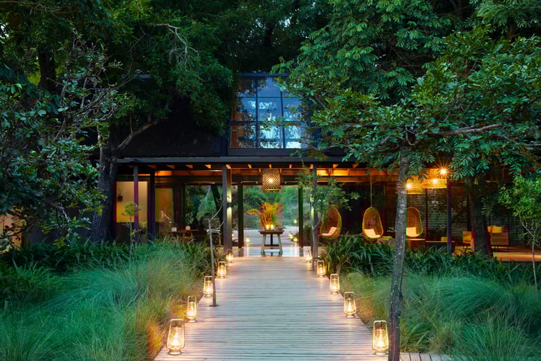 Lion Sands Ivory Lodge | Exclusive Tours RIVER_ENTRANCE_WALKWAY_EVENING