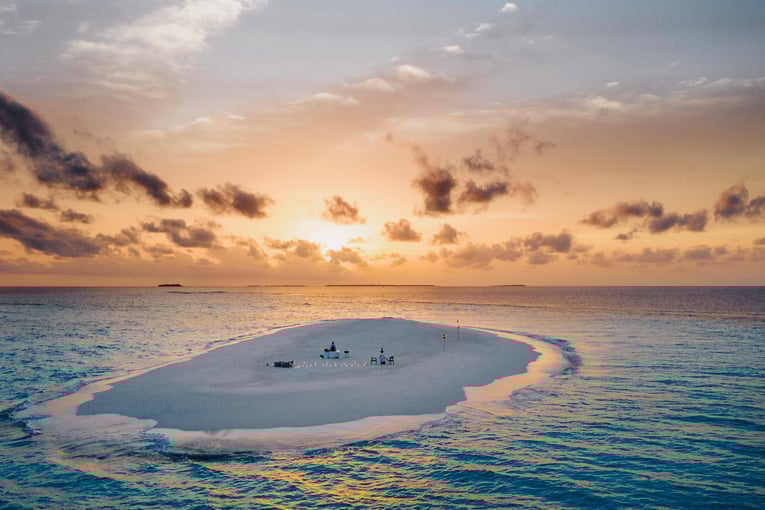 One&Only Reethi Rah OO_RR_Beach_SandBank_Dinner_Twilight_Drone_4093_MASTER